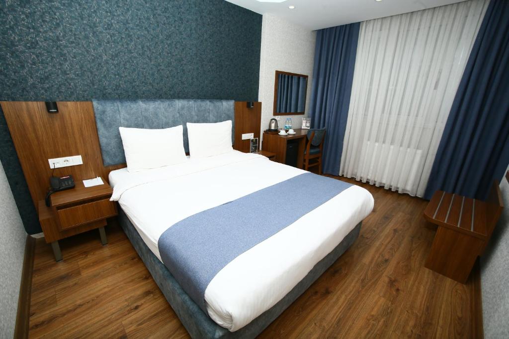 Postel nebo postele na pokoji v ubytování BUKAVİYYE HOTEL