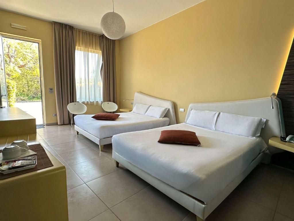 Postel nebo postele na pokoji v ubytování ibis Styles Catania Acireale