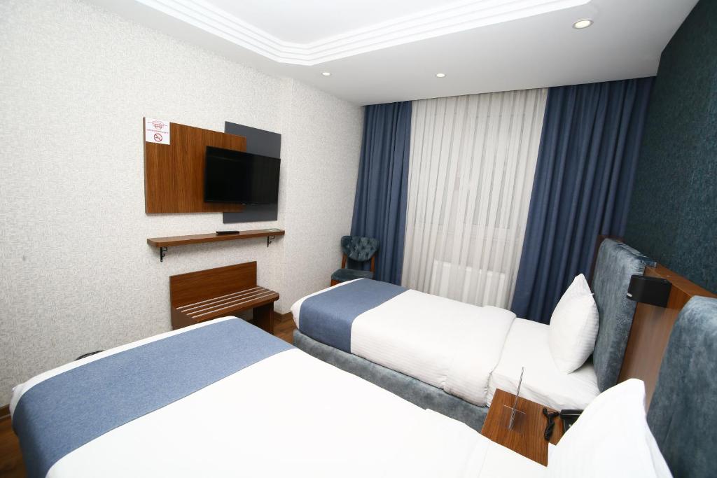 Postel nebo postele na pokoji v ubytování BUKAVİYYE HOTEL