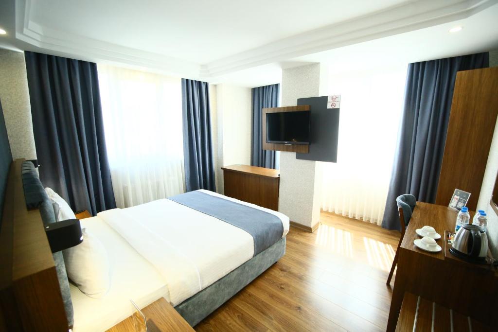 Postel nebo postele na pokoji v ubytování BUKAVİYYE HOTEL