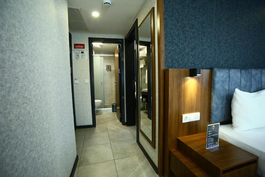 Postel nebo postele na pokoji v ubytování BUKAVİYYE HOTEL