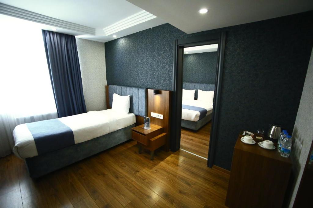 Postel nebo postele na pokoji v ubytování BUKAVİYYE HOTEL