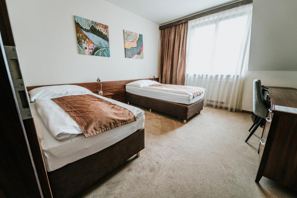 Postel nebo postele na pokoji v ubytování Penzion Drak