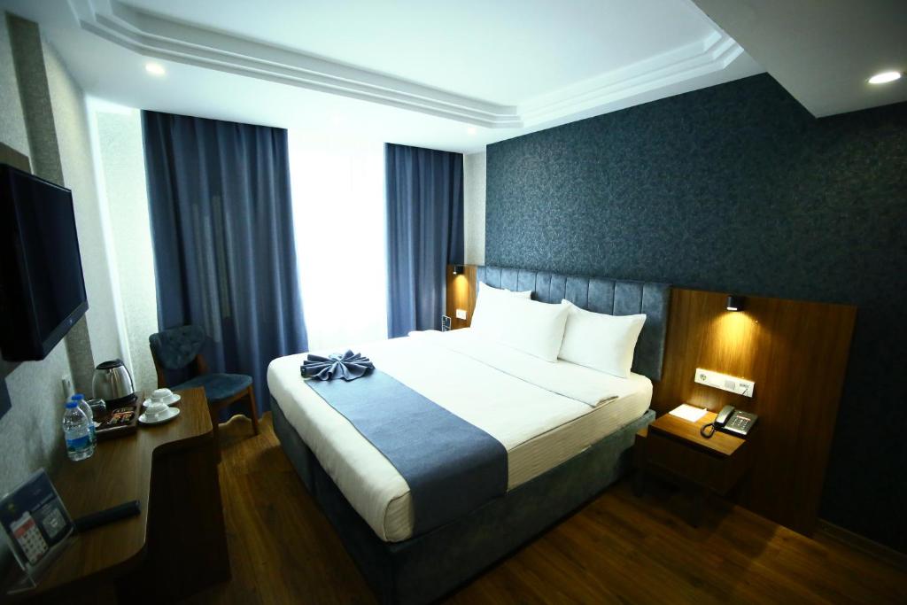 Postel nebo postele na pokoji v ubytování BUKAVİYYE HOTEL