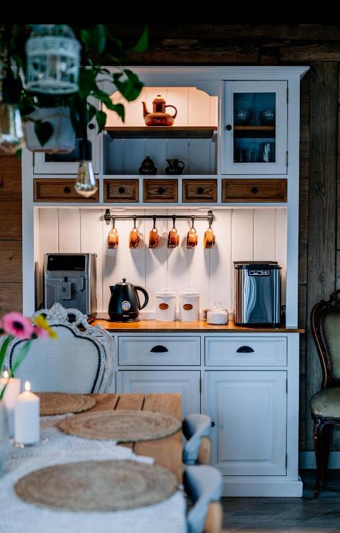 a kitchen with white cabinets and a counter top at Chlewiska nad Świnką in Narol