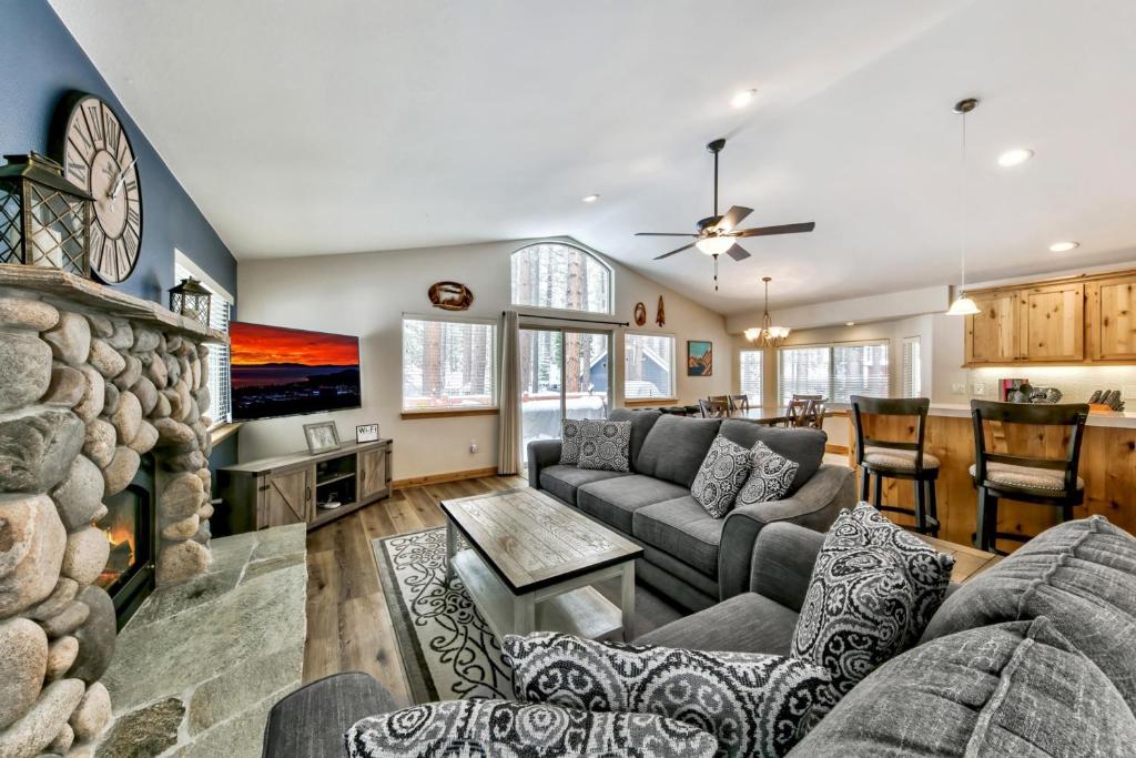 a living room with a couch and a fireplace at Grand Cabin Paradise - Beautiful Yard BBQ Forest in South Lake Tahoe