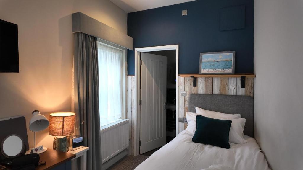 a bedroom with a bed and a window at Downs Hotel in Stanmer