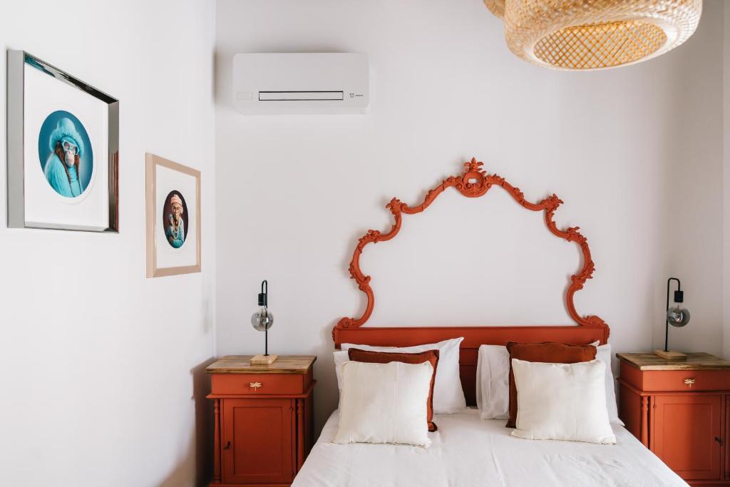 a bedroom with a bed with a wooden headboard at La Bianca Dimora B&B in Gioia del Colle