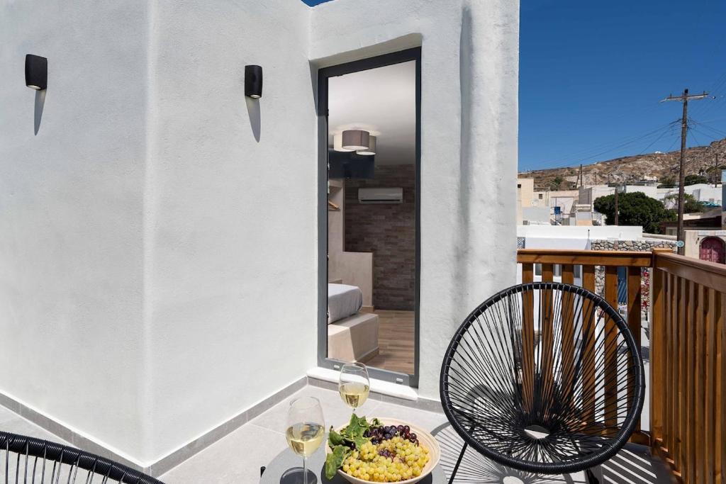 a table with a bowl of food on a balcony at Petit Suite in Emporio