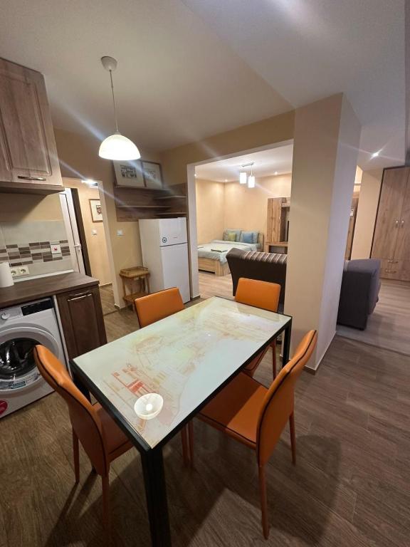 a kitchen and living room with a table and chairs at Danube View 2 in Vidin