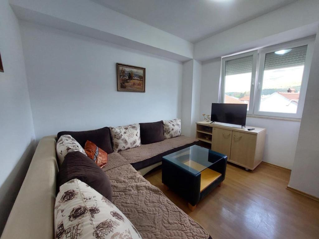 un salon avec un canapé et un bureau dans l'établissement Dora Apartment, à Ohrid