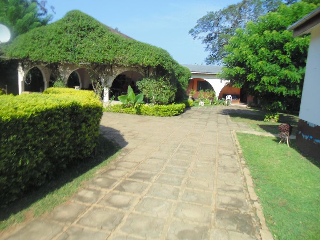 a garden with a pavilion covered in ivy at Wli Water Heights Hotel in Wli Afegame