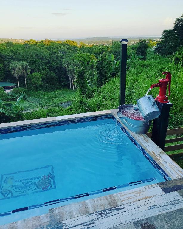 a large swimming pool with a water fountain at Kassa Wista Azzul Rentals-with pool in Hormigueros