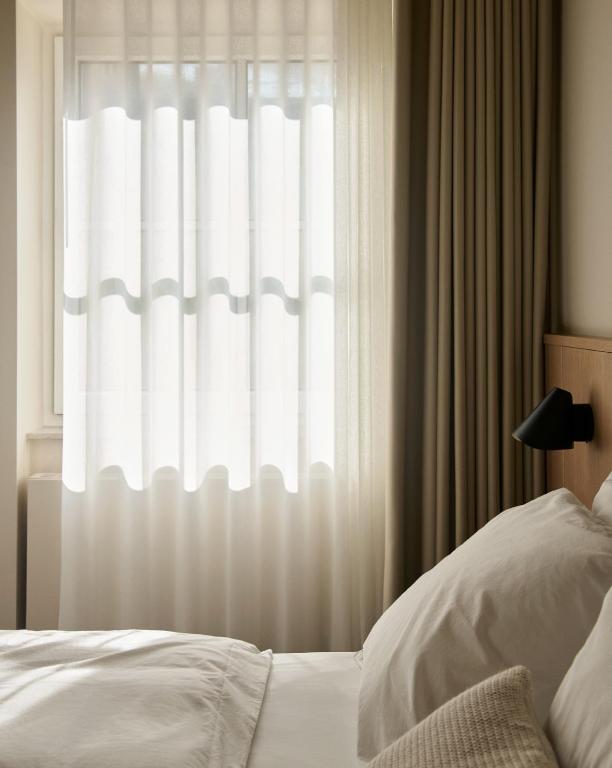 Postel nebo postele na pokoji v ubytování Hotel Petra