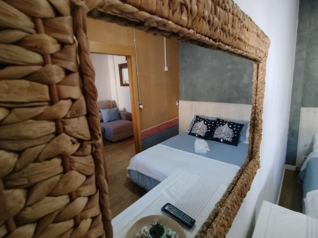 a bedroom with a bed in a large room with a mirror at Casa de Mar in Barrio-Mar