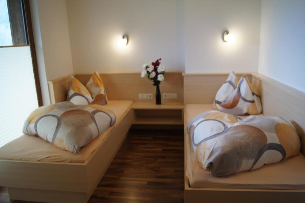 two beds with pillows on them in a room at Familienferienhaus Florentine in Längenfeld