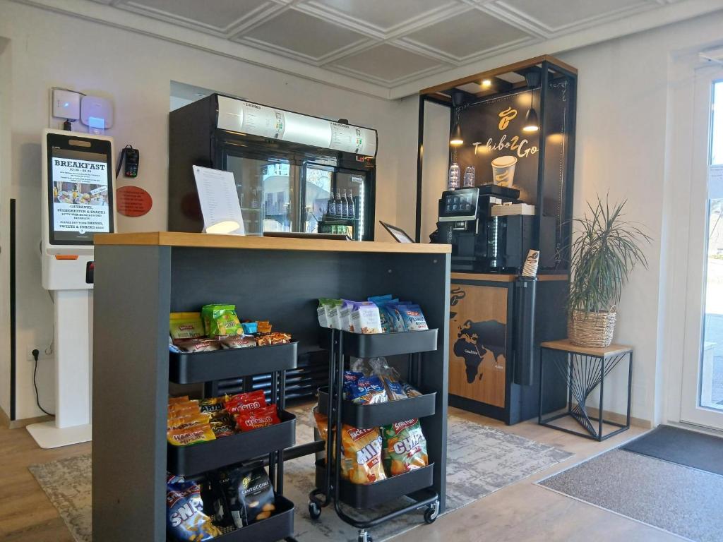 a store with a shelf with food on it at Hotel Fuchs & Hase SELF CHECK IN in Rosegg