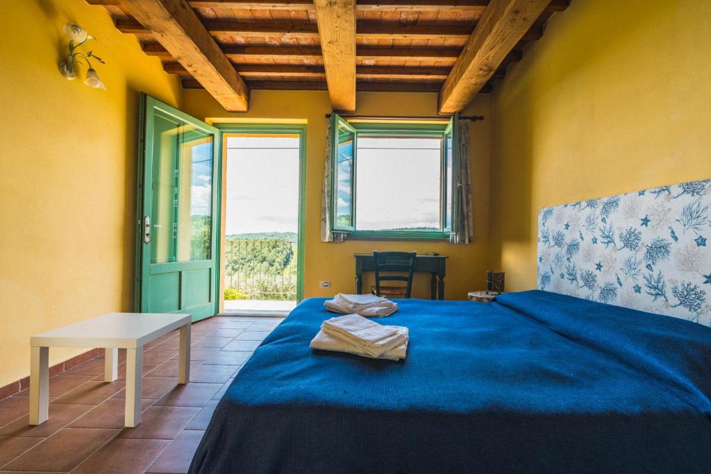 Postel nebo postele na pokoji v ubytování Borgo De Salaioli