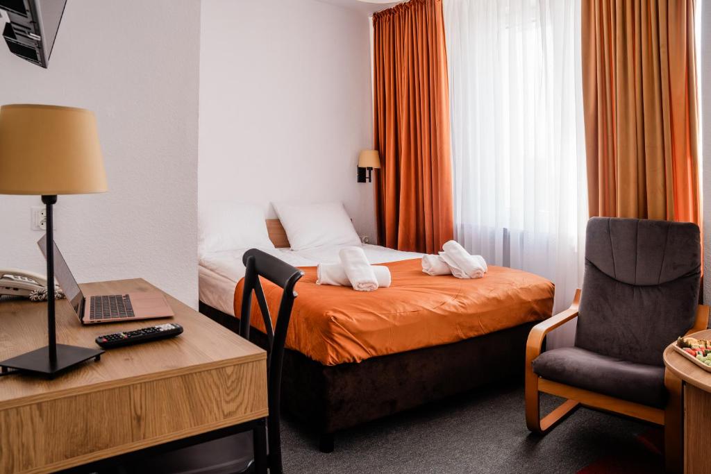 Posteľ alebo postele v izbe v ubytovaní Hotel Wodnik