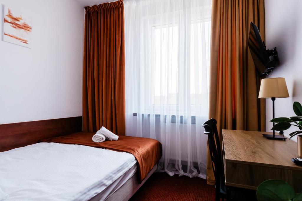 Posteľ alebo postele v izbe v ubytovaní Hotel Wodnik