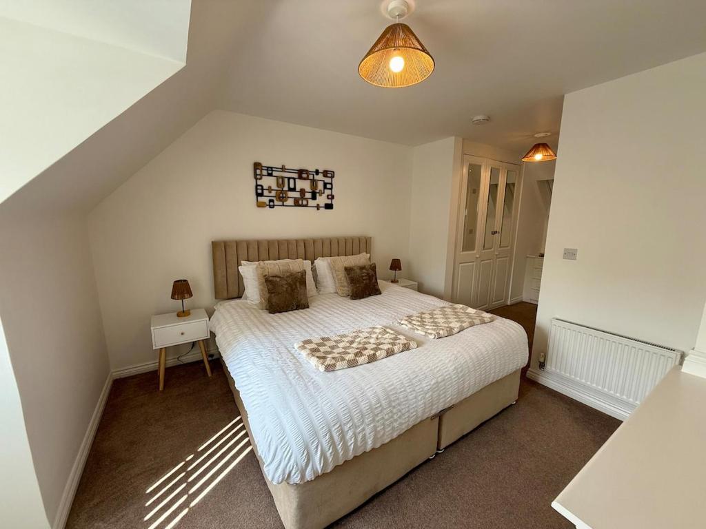 a bedroom with a large bed in a room at The Lakes in Stockingford