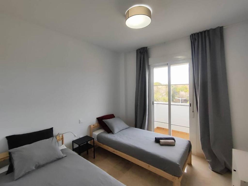 Postel nebo postele na pokoji v ubytování Apartamento Happy Days