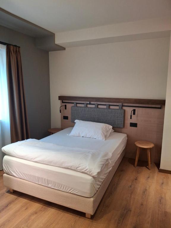 Postel nebo postele na pokoji v ubytování Hotel Dolomiti Saone
