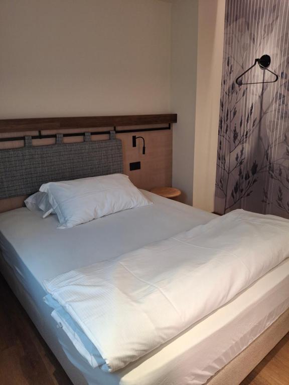 Postel nebo postele na pokoji v ubytování Hotel Dolomiti Saone