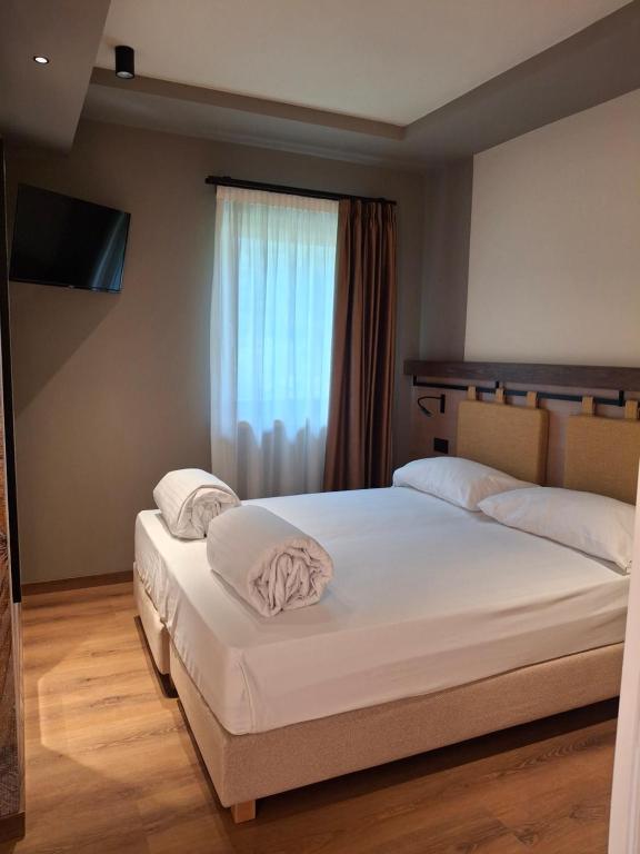 Postel nebo postele na pokoji v ubytování Hotel Dolomiti Saone