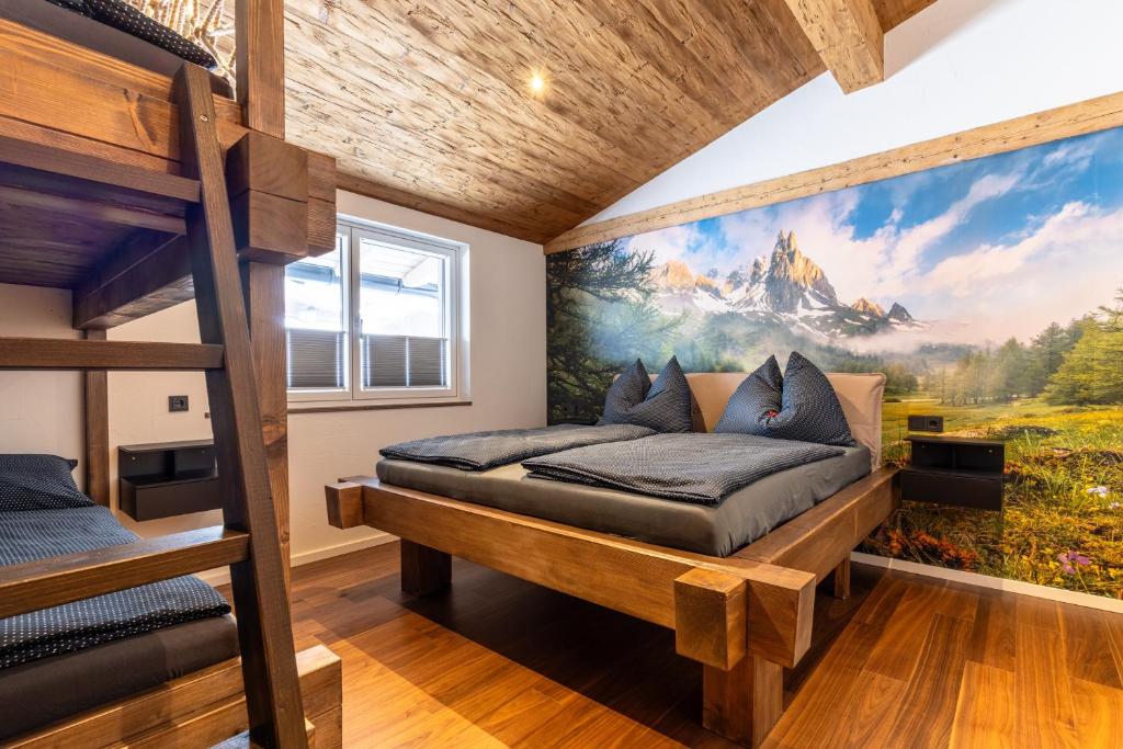 a bedroom with a bunk bed and a mural at Appartement Hoamatgfüh in Saalbach-Hinterglemm