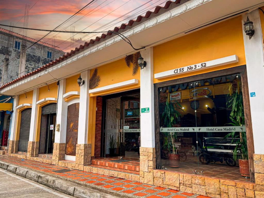 a store front of a building with windows at Hotel Casa Madrid in Puerto Berrío