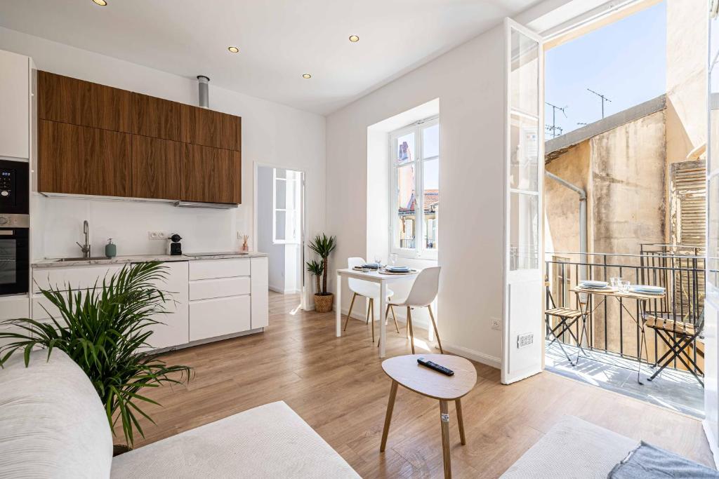 une cuisine et un salon avec une table et des chaises dans l'établissement Appartement neuf 2 pièces Port, à Nice