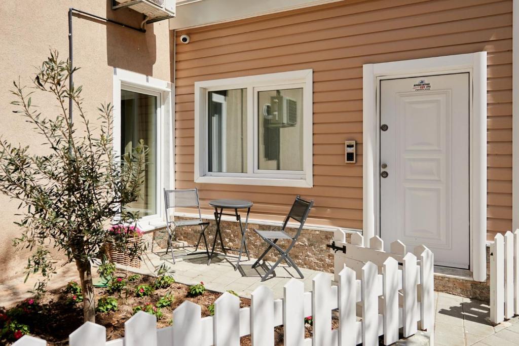 a porch with a table and chairs in front of a house at Apartment Ivan in Pomorie