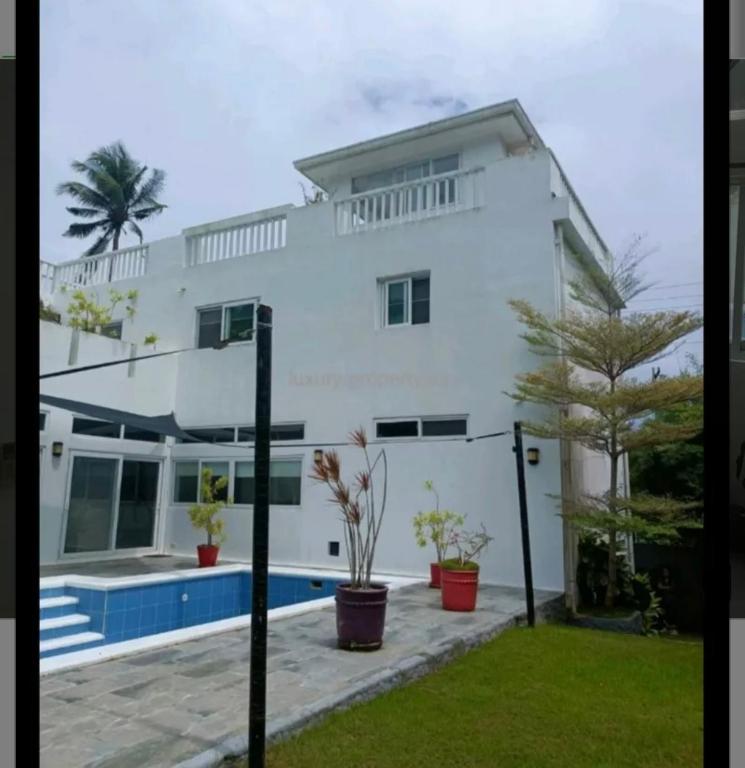 a white house with a pool in front of it at Beautiful house in Boracay Aklan in Boracay