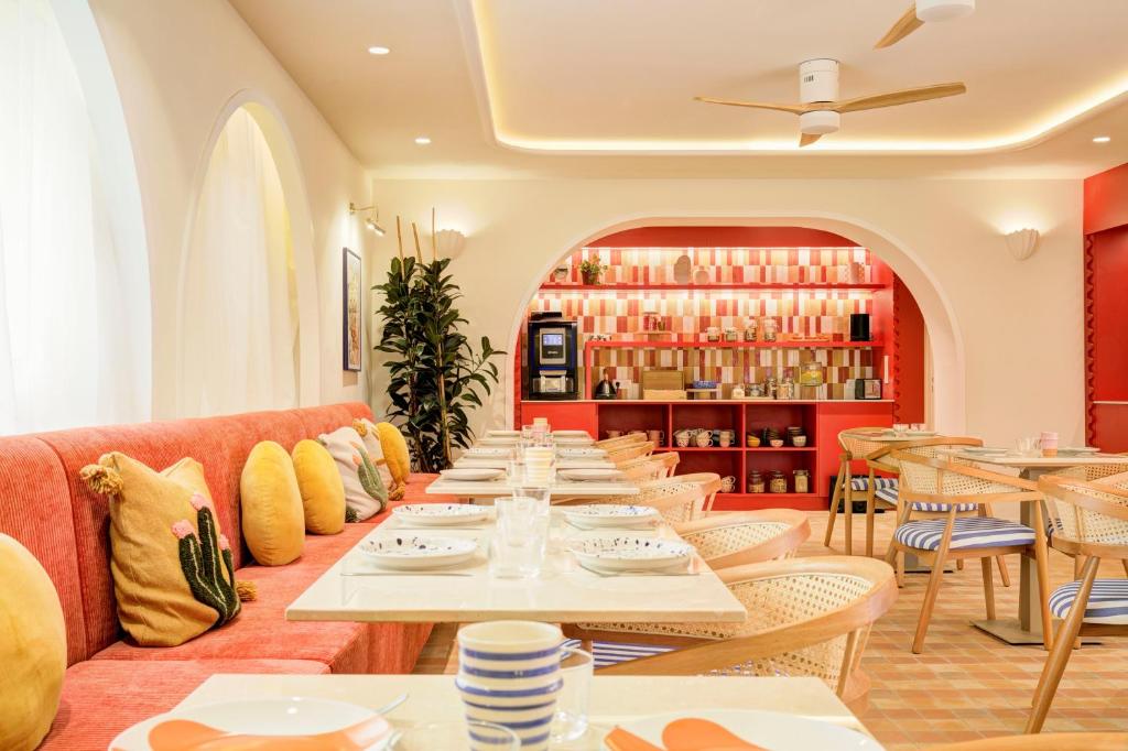 a long dining room with tables and chairs at Hôtel Gabriel in Menton
