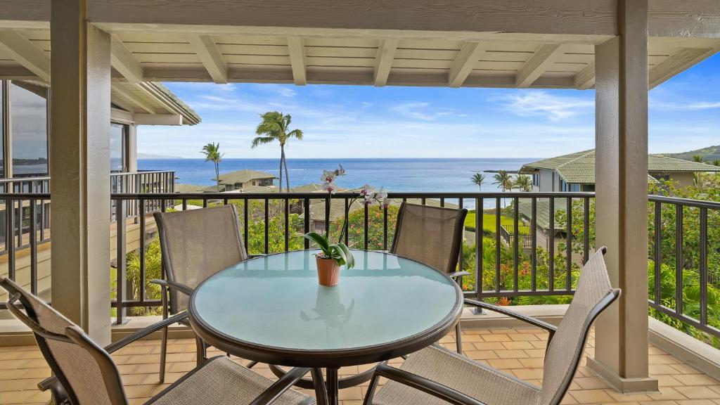a table and chairs on a balcony with a view of the ocean at Kapalua Bay Villa 17B4 in Kapalua