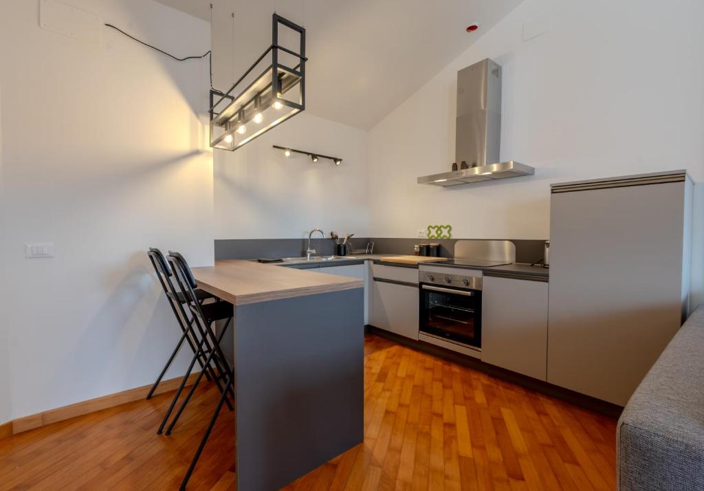 a kitchen with stainless steel appliances and a counter at Loft Empoli in Empoli