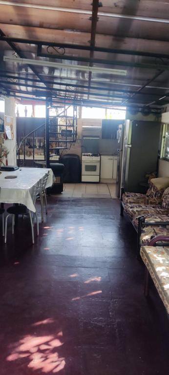 a large room with tables and beds in it at Habitacion Donde Emita in Santiago