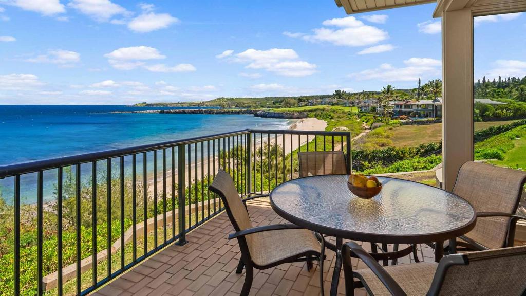 a balcony with a table and chairs and the ocean at Kapalua Bay Villa 21G2 in Kapalua