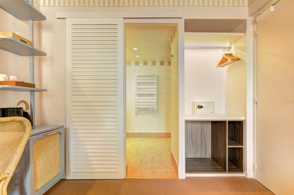a closet with a door leading into a room at Hôtel Gabriel in Menton