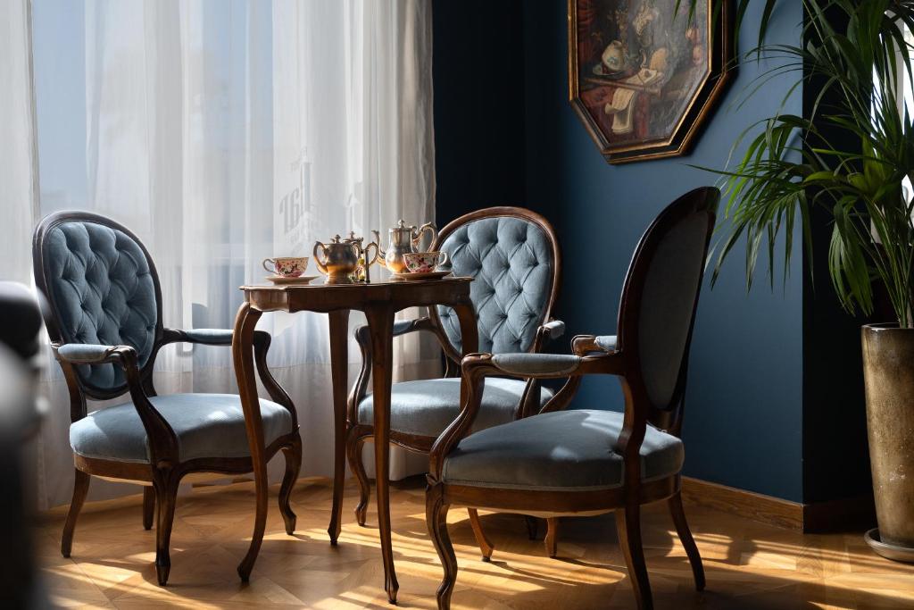 a dining room with two chairs and a table at Palace Hotel in Viareggio