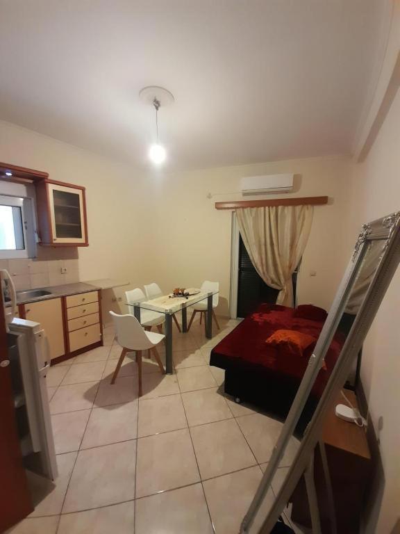 a bedroom with a bed and a table and chairs at calmia in Lefkada