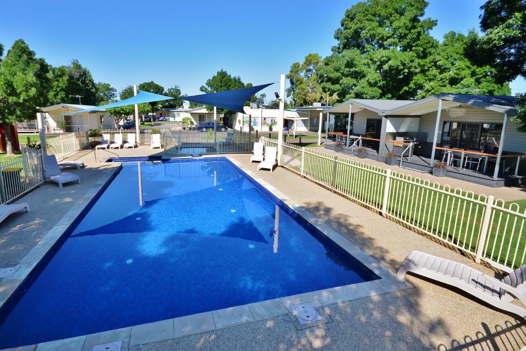 a large blue swimming pool next to a fence at BIG4 Mildura Getaway in Mildura