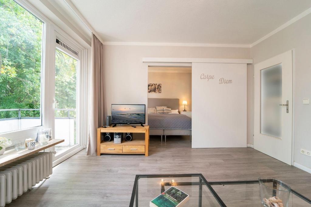 TV a/nebo společenská místnost v ubytování Höppnerweg 5 Carpe Diem Timmendorfer Strand