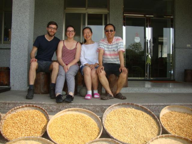 a group of people sitting on a bench in front of food at Taroko Sialin Coffee Farm Homestay in Xiulin