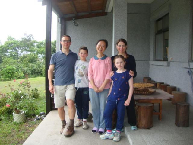 a family posing for a picture in front of a house at Taroko Sialin Coffee Farm Homestay in Xiulin