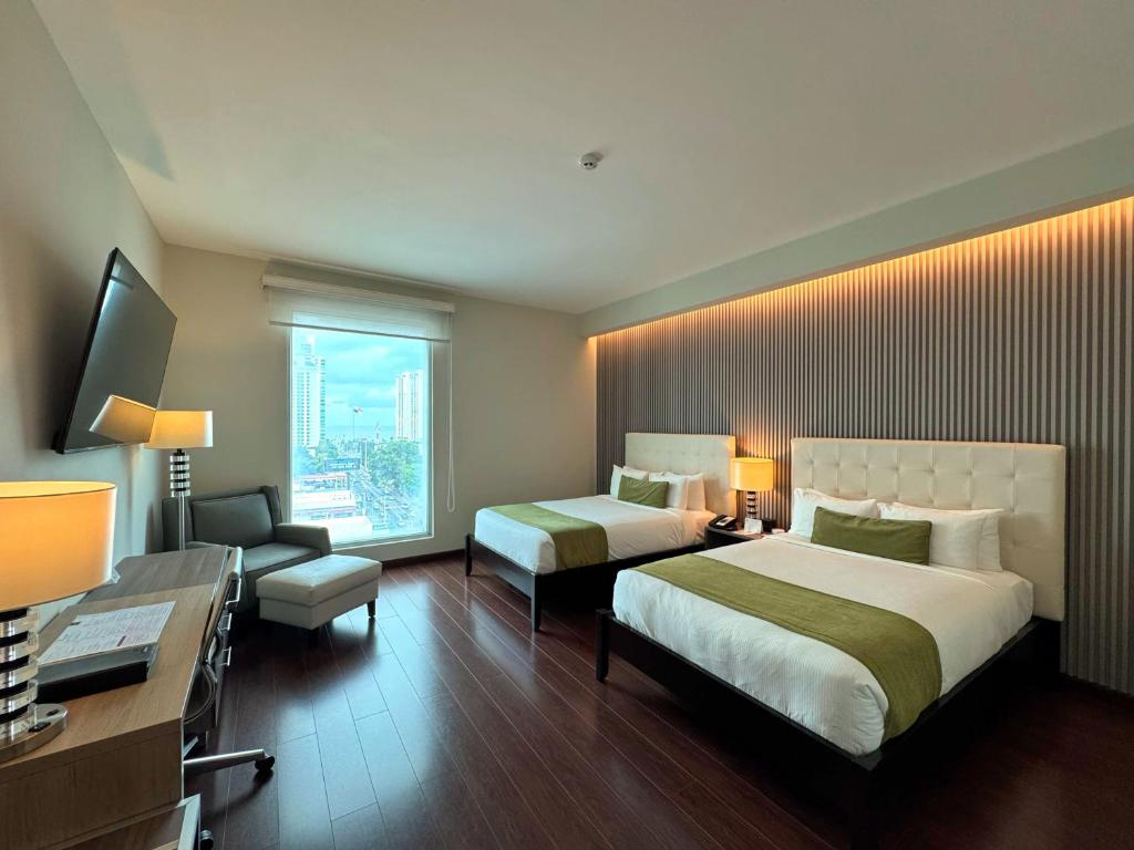 Postel nebo postele na pokoji v ubytování Ramada Plaza by Wyndham Panama Punta Pacifica