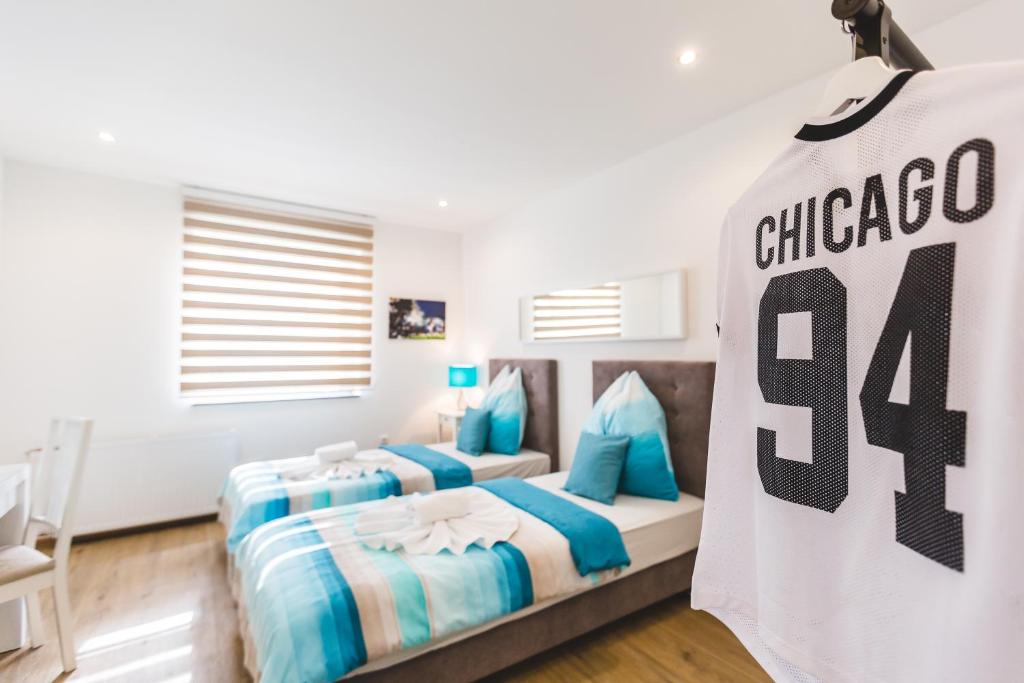 a bedroom with two beds and a jersey on the wall at Motel Touchdown & Restaurant in Lohmar