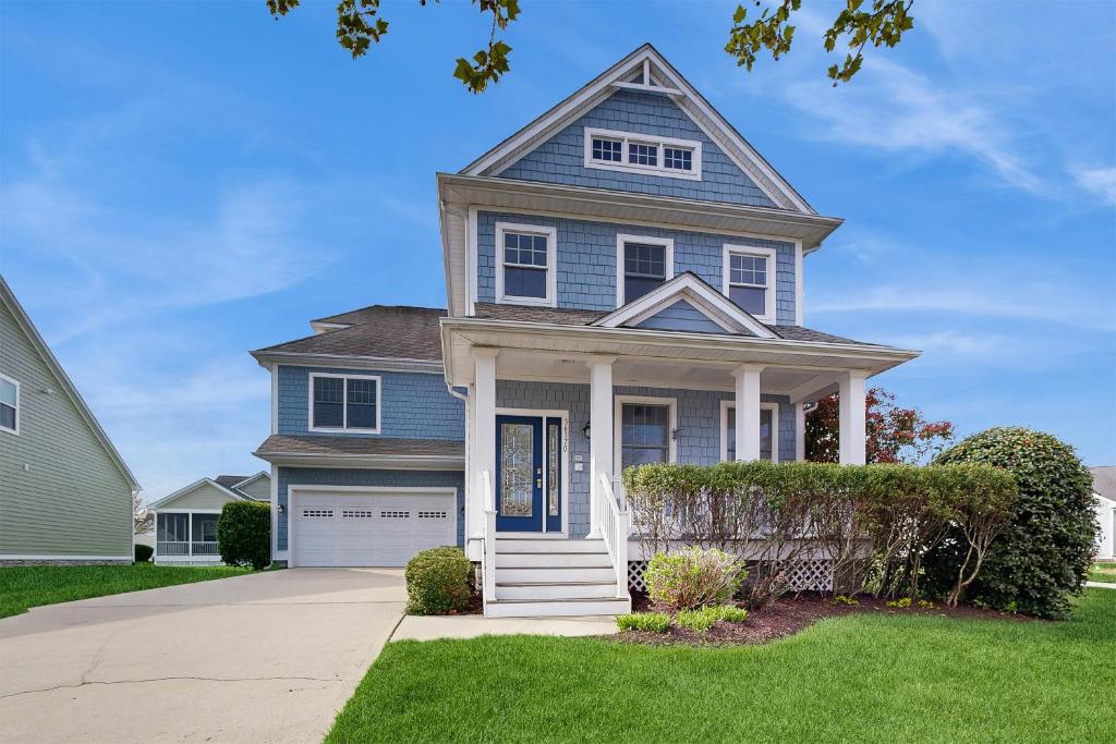 a blue house with a white door at Bayside Resort --- 36370 Day Lilly Pkwy in Selbyville