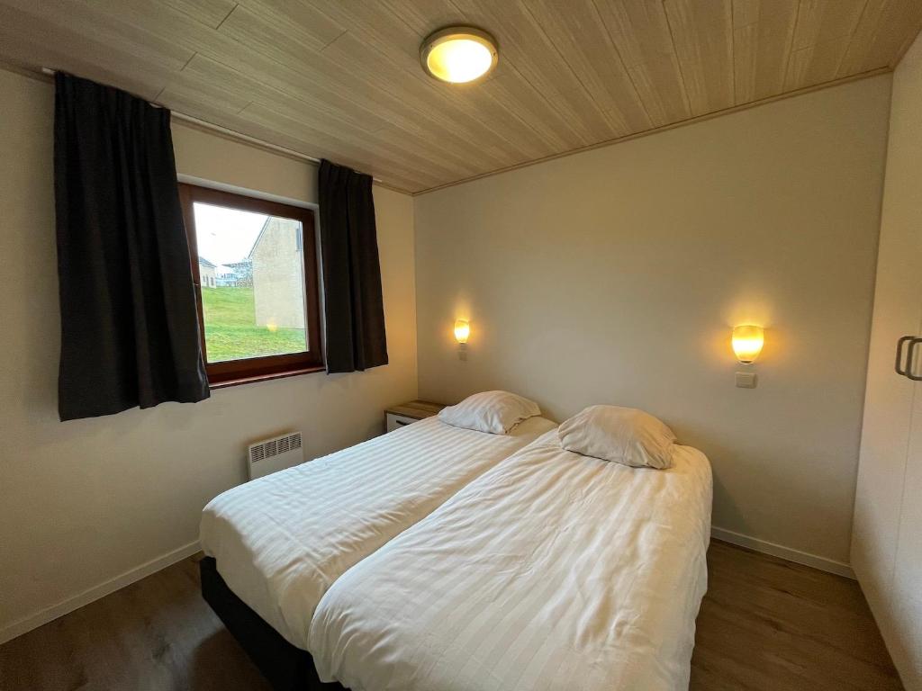 Postel nebo postele na pokoji v ubytování Holiday Park La Sapinière